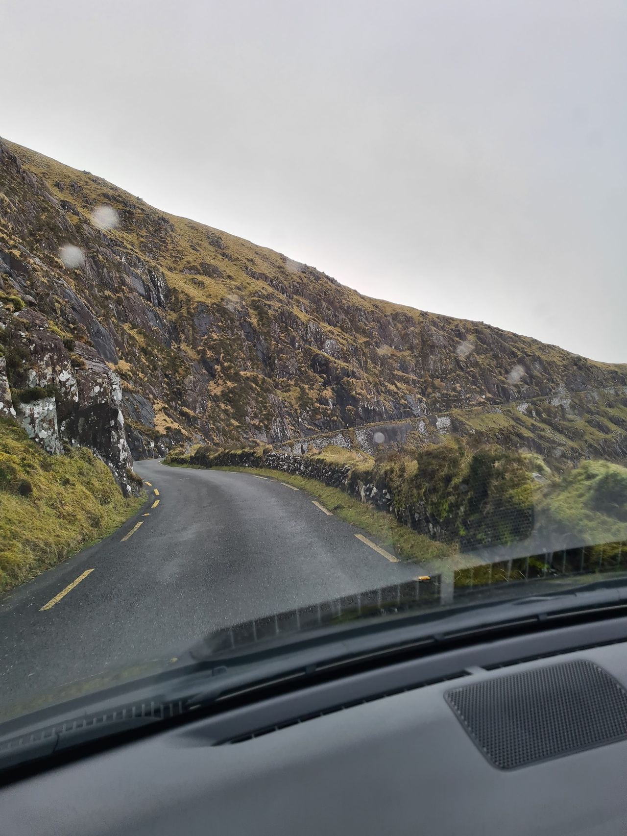 Narrow mountain road on a cloudy day