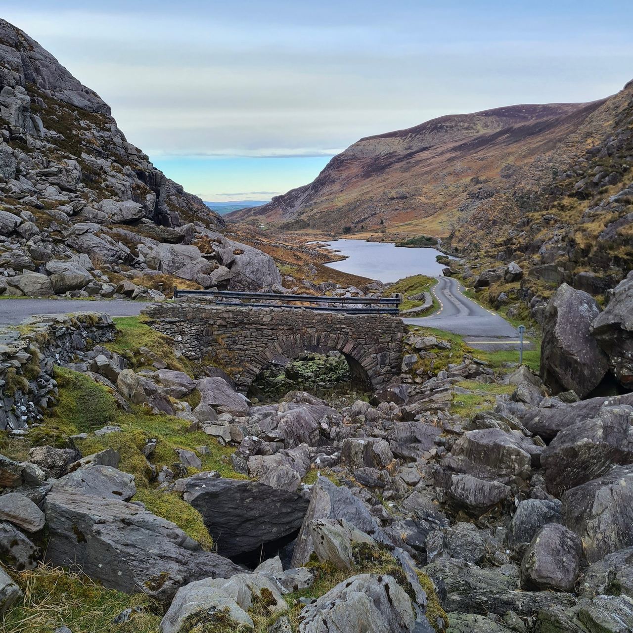 Gap between two small mountains with a stream and small rock in it