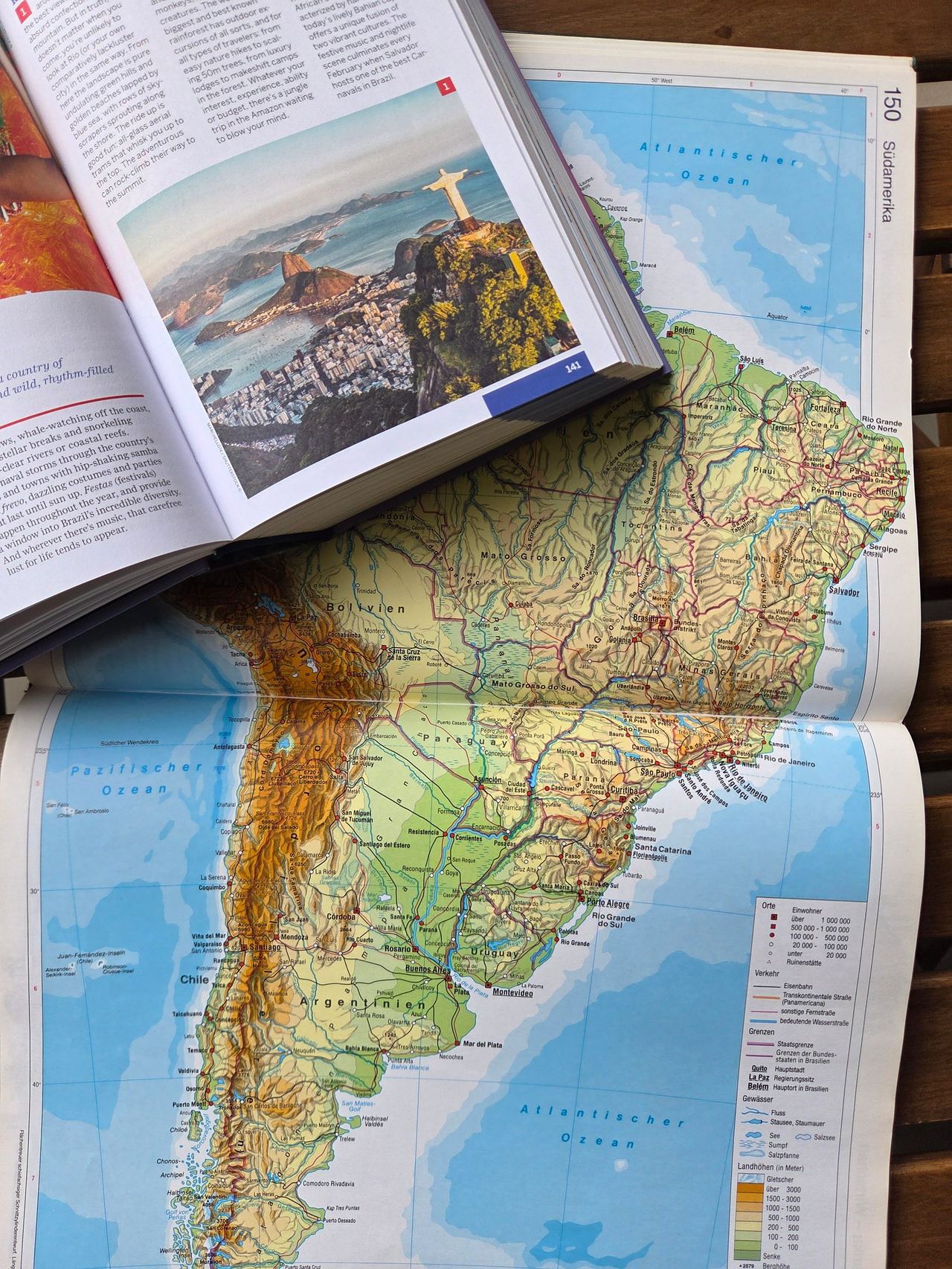Travel book opened at Brazil on a map.