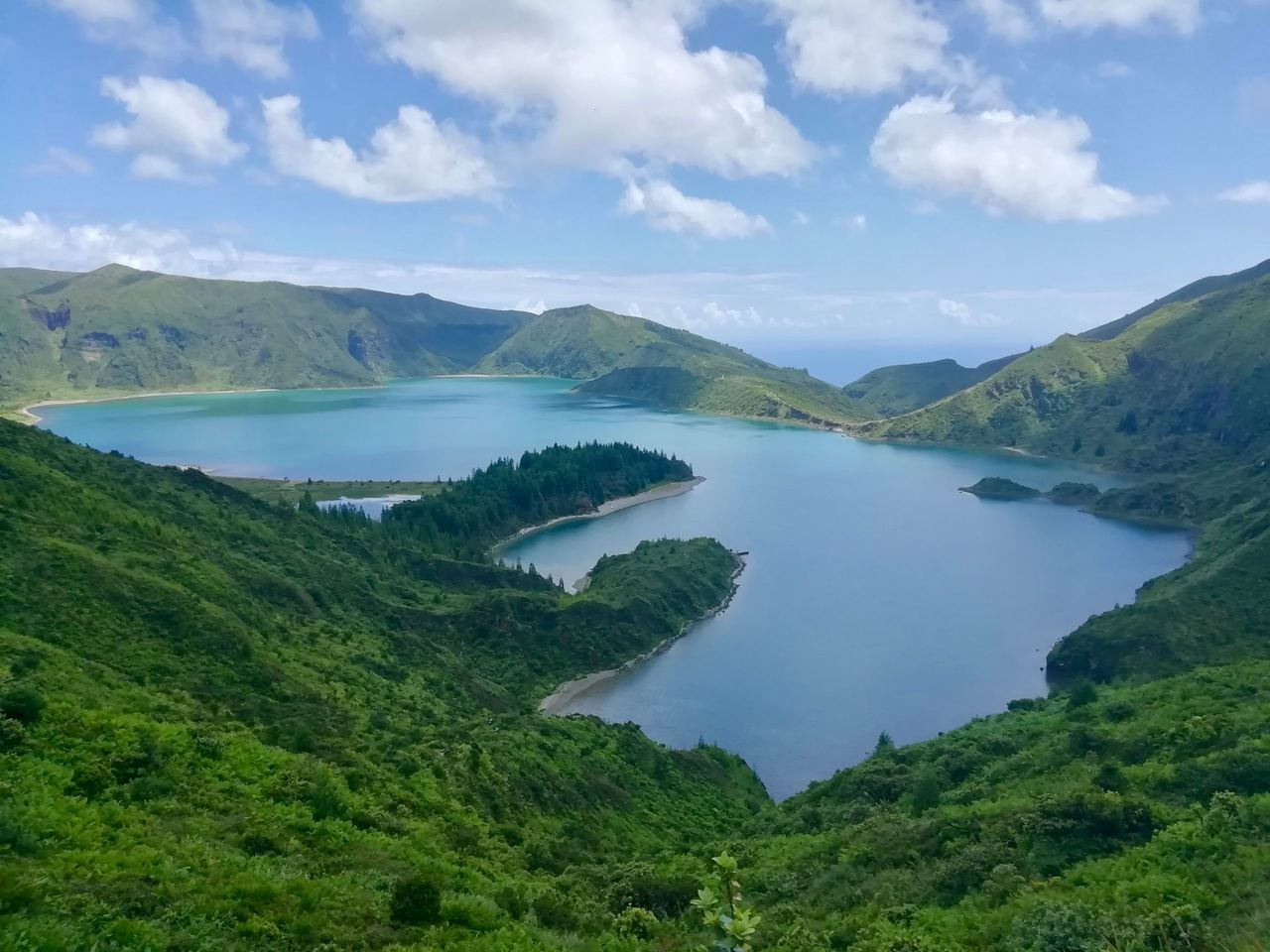 Crater lake in the middle of a green valley